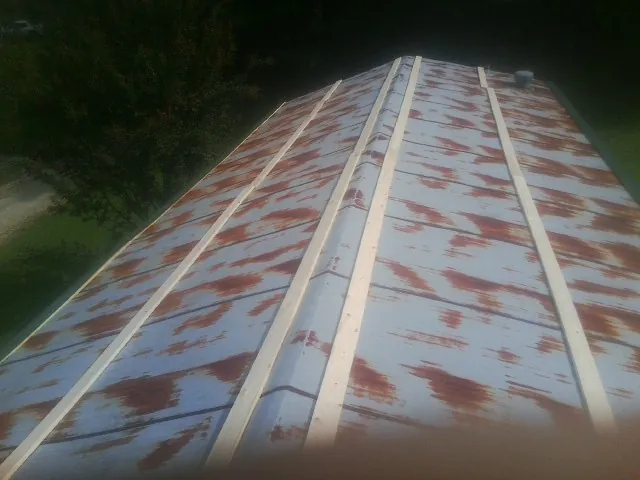 Rusted metal roof panels with new wood purlins before replacement — Storm Damage Roof Repair in New Vernon by Roofing Brothers