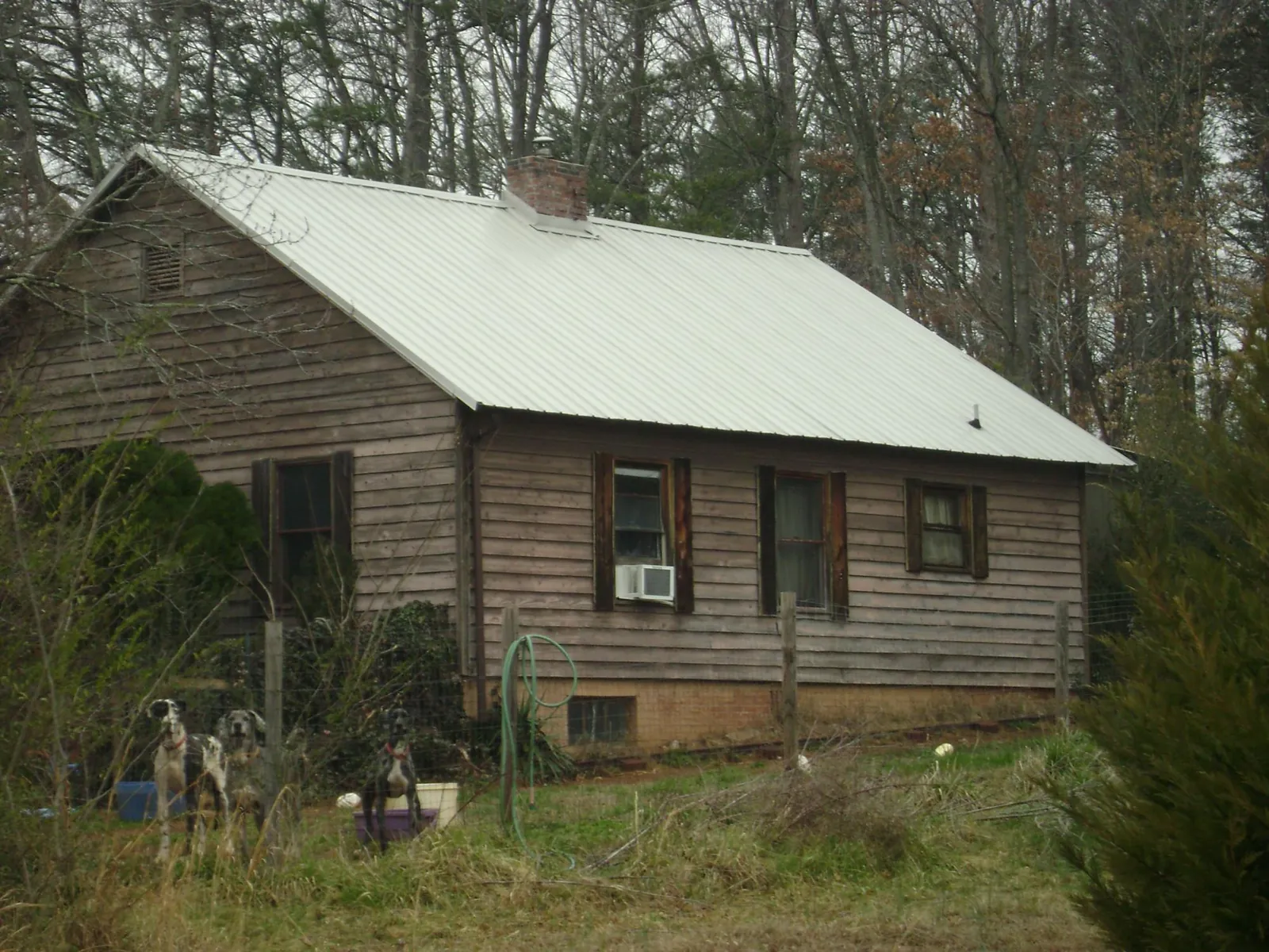White metal roof on an old wood sided farmhouse, from a Metal Roof Installation job in New Vernon